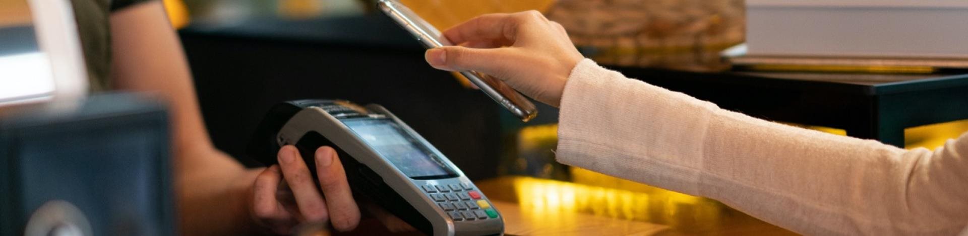 Person making mobile payment at store checkout
