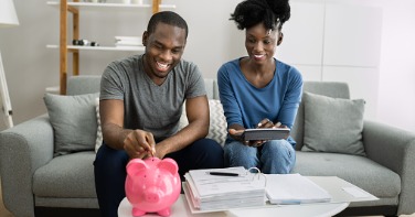 Couple meeting with piggy bank